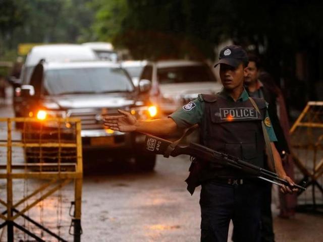 A policeman keep watch as a Japanese convoy with relatives of victims of the attack on Holey Artisan Bakery visited the site in Dhaka. (Reuters) A policeman keep watch as a Japanese convoy with relatives of victims of the attack on Holey Artisan Bakery visited the site in Dhaka. (Reuters)
