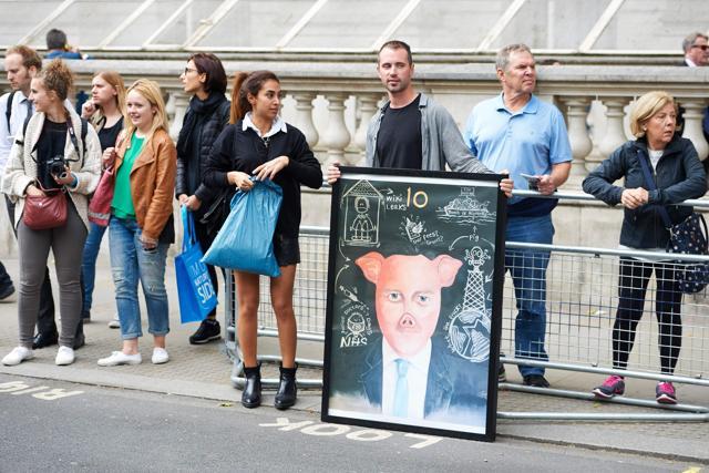 A demonstrator displays a painting depicting former British prime minister David Cameron in central London. (AFP Photo) A demonstrator displays a painting depicting former British prime minister David Cameron in central London. (AFP Photo)