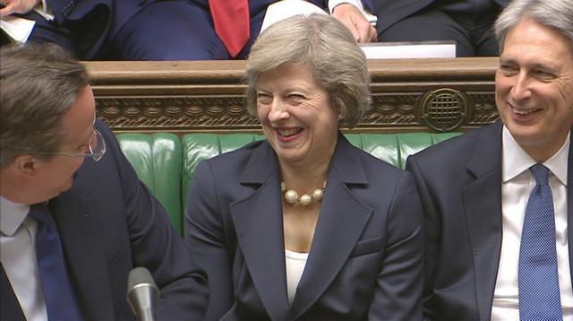 Britain's outgoing Prime Minister David Cameron (left) speaks to incoming prime minister Theresa May during Prime Minister's Questions in the House of Commons, in central London. (Reuters Photo)