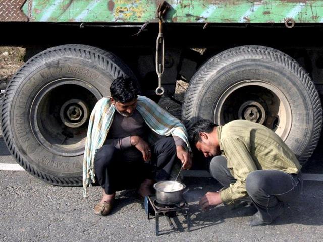 Stranded drivers prepare tea on a kerosene stove in front of a supply truck on the Jammu Srinagar national highway on the outskirts of Jammu. (Reuters file photo) Stranded drivers prepare tea on a kerosene stove in front of a supply truck on the Jammu Srinagar national highway on the outskirts of Jammu. (Reuters file photo)