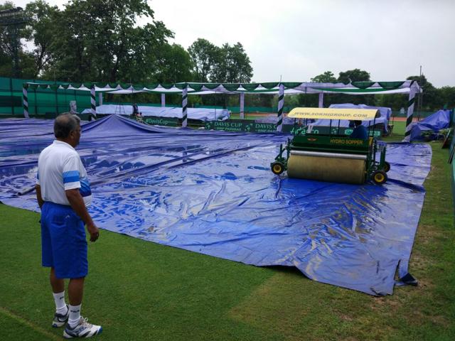 Bengal Tennis Association president Hiranmoy Chatterjee oversees the Super Sopper drying up water from the top of the covers before they can be removed. With more rain predicted over the weekend, it could be a very wet Davis Cup tie between India and South Korea in Chandigarh. (Sukhwant Basra ) Bengal Tennis Association president Hiranmoy Chatterjee oversees the Super Sopper drying up water from the top of the covers before they can be removed. With more rain predicted over the weekend, it could be a very wet Davis Cup tie between India and South Korea in Chandigarh. (Sukhwant Basra )