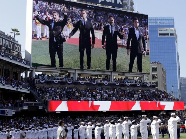 The Tenors, shown on the scoreboard, caused a stir with Remigio Pereira's actions while singing "O Canada" prior to the MLB baseball All-Star Game, in San Diego. (AP) The Tenors, shown on the scoreboard, caused a stir with Remigio Pereira's actions while singing "O Canada" prior to the MLB baseball All-Star Game, in San Diego. (AP)
