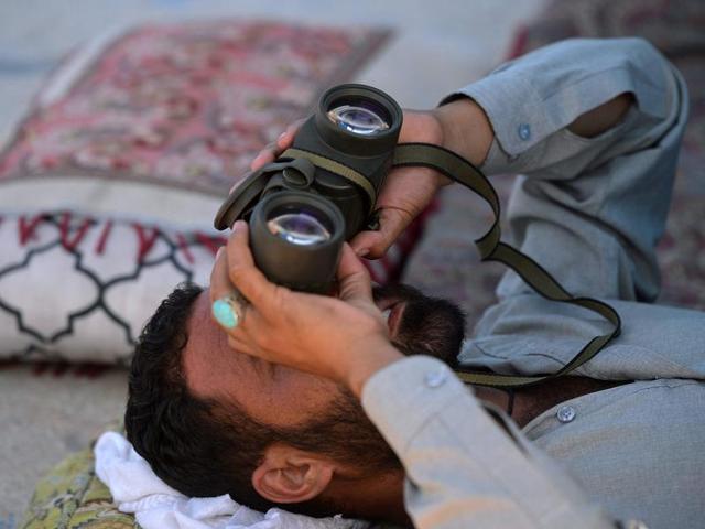 A man watches racing pigeons in Islamabad. (AFP)