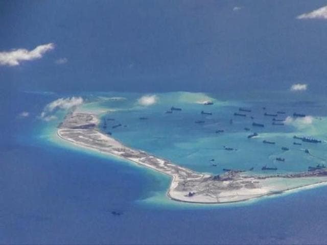 Chinese dredging vessels are purportedly seen in the waters around Mischief Reef in the disputed Spratly Islands in the South China Sea. (Reuters File) Chinese dredging vessels are purportedly seen in the waters around Mischief Reef in the disputed Spratly Islands in the South China Sea. (Reuters File)