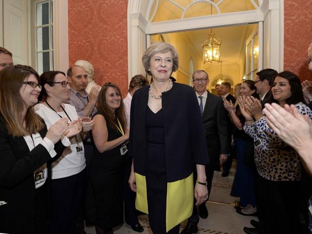 Staff applaud as Britain's new Prime Minister Theresa May, and her husband Philip, walk into 10 Downing Street after May had met Queen Elizabeth in Buckingham Palace, in central London. (Reuters Photo) Staff applaud as Britain's new Prime Minister Theresa May, and her husband Philip, walk into 10 Downing Street after May had met Queen Elizabeth in Buckingham Palace, in central London. (Reuters Photo)