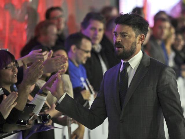 Karl Urban, who plays Leonard ‘Bones’ McCoy, hi-fives fans as he walks on the red carpet during the premiere of the film Star Trek Beyond in Sydney. (AP) 