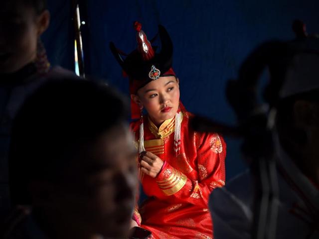 Naadam has existed for centuries in Mongolia in some form or the other. It has its origins in the military parades and sports competitions that followed various occasions including weddings and spiritual gatherings. A Mongolian artist looks on at a tent as she prepares to perform during the festival. (AFP) Naadam has existed for centuries in Mongolia in some form or the other. It has its origins in the military parades and sports competitions that followed various occasions including weddings and spiritual gatherings. A Mongolian artist looks on at a tent as she prepares to perform during the festival. (AFP)