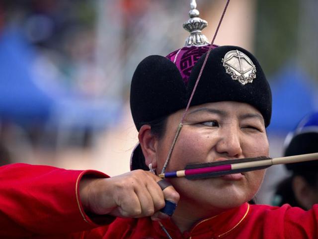 Traditionally, only men participated in the festival. However, archery and horse-riding have witnessed the participation of women. A woman draws her bow. (AP) Traditionally, only men participated in the festival. However, archery and horse-riding have witnessed the participation of women. A woman draws her bow. (AP)
