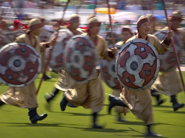 The festival is held all over Mongolia but the biggest one, the National Naadam, takes places the Mongolian capital Ulaanbaator during its national holiday (July 11 - 13). Performers carrying spears and shields run across the field as part of the festival. (AP) The festival is held all over Mongolia but the biggest one, the National Naadam, takes places the Mongolian capital Ulaanbaator during its national holiday (July 11 - 13). Performers carrying spears and shields run across the field as part of the festival. (AP)