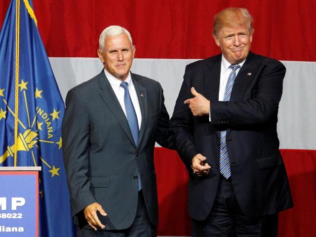 Republican presidential candidate Donald Trump (R) and Indiana Governor Mike Pence (L) wave to the crowd before addressing the crowd during a campaign stop at the Grand Park Events Center in Westfield.(REUTERS)