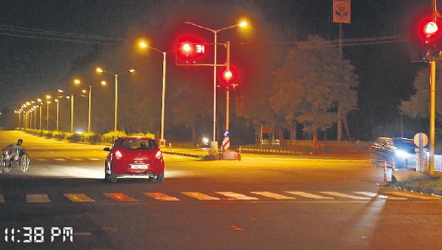 A car jumping the red light, while at the same time, a differently abled man also crossing the road, at Modern Complex, Manimajra light point. (Sanjeev Sharma/HT Photo) A car jumping the red light, while at the same time, a differently abled man also crossing the road, at Modern Complex, Manimajra light point. (Sanjeev Sharma/HT Photo)