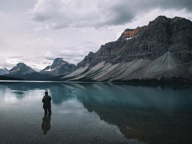 Though he usually uses a timer to shoot himself he was lucky to see a fisherman he could use for a model instead while photographing Bow Lake in Canada. (Instagram) 