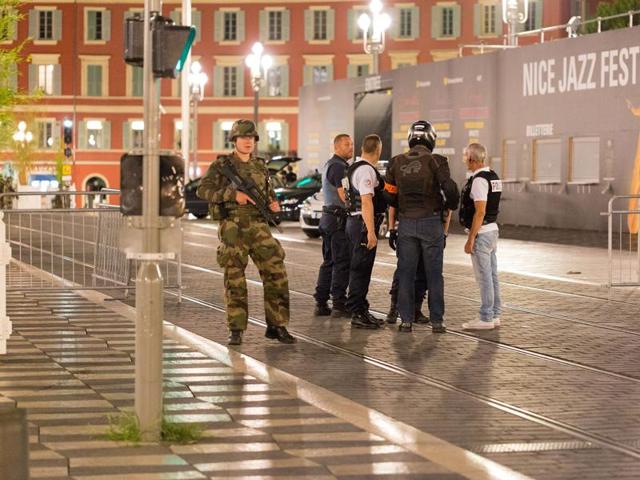 Police officers and a soldier stand guard near the sealed-off area of the truck attack. (AP) Police officers and a soldier stand guard near the sealed-off area of the truck attack. (AP)