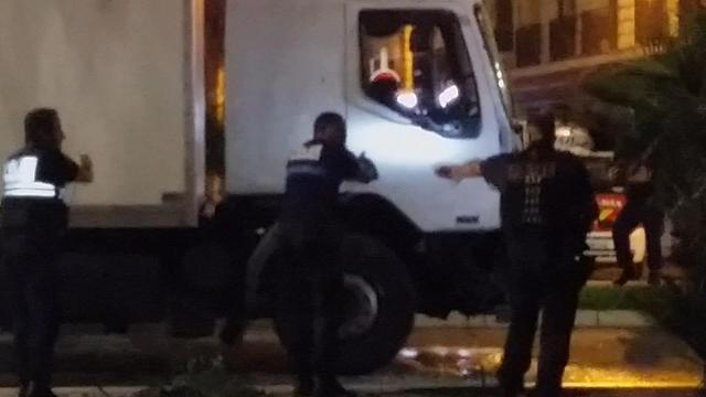 Police shine a light into the cab as they approach the driver's cab of a truck, in Nice. (AP) Police shine a light into the cab as they approach the driver's cab of a truck, in Nice. (AP)