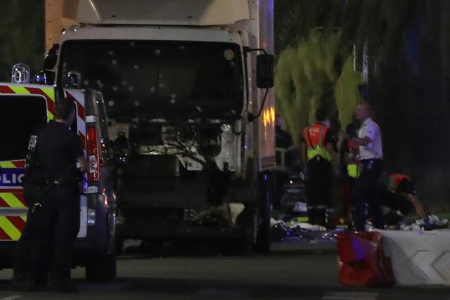 Police officers stand near a van, with its windscreen riddled with bullets, that ploughed into a crowd leaving a fireworks display in the French Riviera town of Nice. (AFP) Police officers stand near a van, with its windscreen riddled with bullets, that ploughed into a crowd leaving a fireworks display in the French Riviera town of Nice. (AFP)