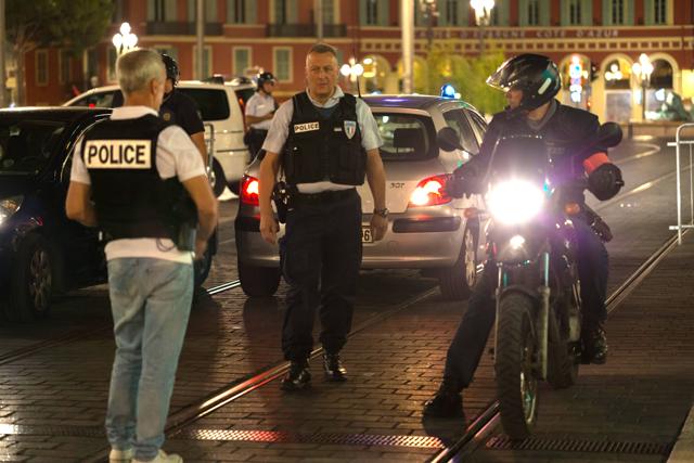 Police officers seal off the area of an attack after a truck drove on to the sidewalk and plowed through a crowd of in Nice last Friday. (AP) Police officers seal off the area of an attack after a truck drove on to the sidewalk and plowed through a crowd of in Nice last Friday. (AP)