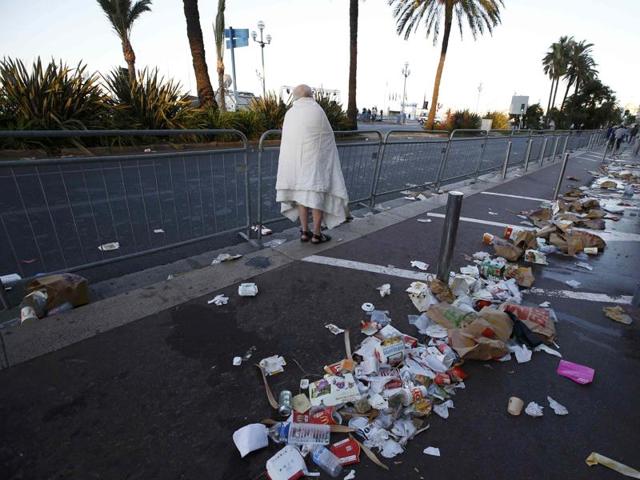 A man walks through debris scatterd on the street on which the attack took place. (REUTERS) A man walks through debris scatterd on the street on which the attack took place. (REUTERS)