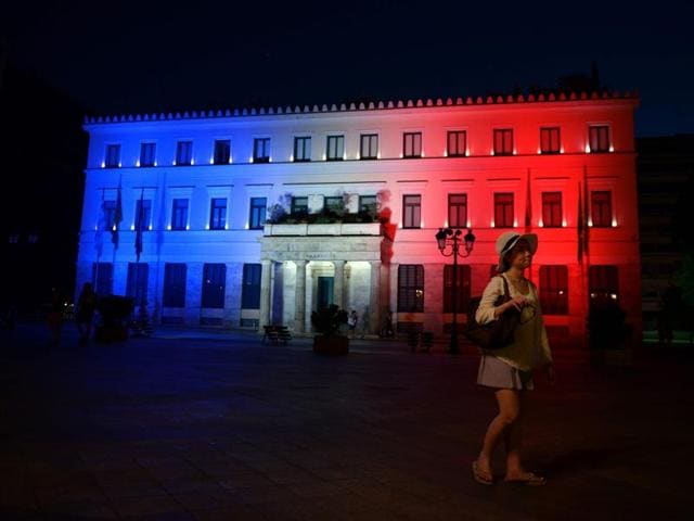 A woman walks past Athens' City Hall, illuminated with the colours of the French flag in tribute for the victims of the attack in Nice, in Athens. (AFP Photo) A woman walks past Athens' City Hall, illuminated with the colours of the French flag in tribute for the victims of the attack in Nice, in Athens. (AFP Photo)