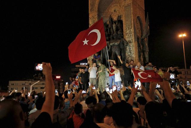 Supporters of Turkey's President Erdogan, gather, waving Turkish flags, in Istanbul's Taksim square, early Saturday. (AP) Supporters of Turkey's President Erdogan, gather, waving Turkish flags, in Istanbul's Taksim square, early Saturday. (AP)