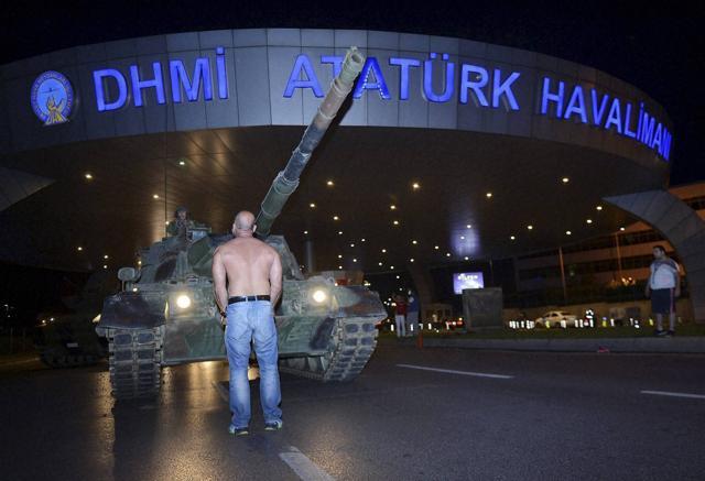 A man stands in front of a tank in the entrance to Istanbul's Ataturk airport early on Saturday. (AP) A man stands in front of a tank in the entrance to Istanbul's Ataturk airport early on Saturday. (AP)