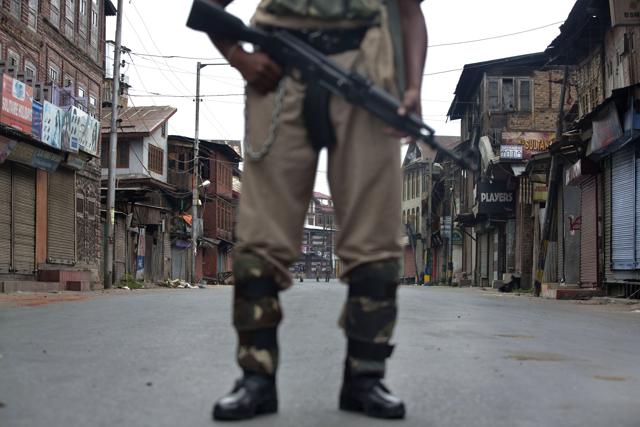 A soldier stands guard during curfew in Srinagar.(AP)