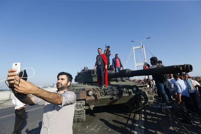 A man takes a selfie in front of a tank after troops involved in the coup surrendered on the Bosphorus Bridge in Istanbul. (Reuters) A man takes a selfie in front of a tank after troops involved in the coup surrendered on the Bosphorus Bridge in Istanbul. (Reuters)