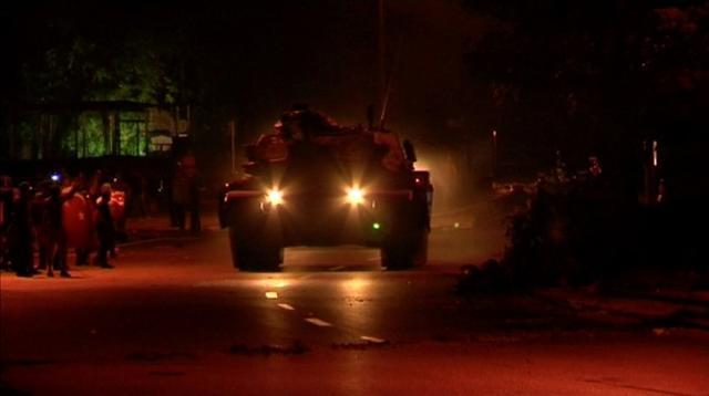 This still frame taken from amateur video obtained by Reuters shows a tank driving past people, in Ankara, Turkey. (Reuters)