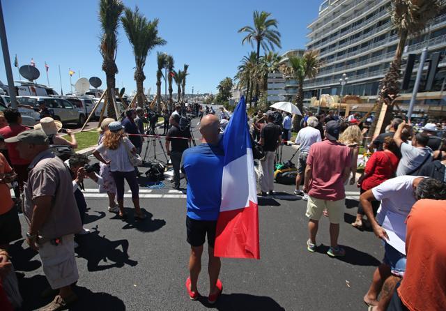 A man holding the French national flag stands near the site of the truck attack in the French resort city of Nice, southern France. (AP Photo) A man holding the French national flag stands near the site of the truck attack in the French resort city of Nice, southern France. (AP Photo)