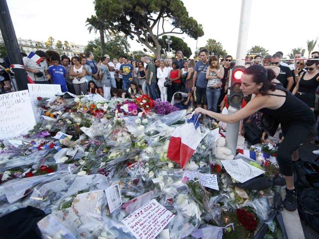 People pay tribute to victims a day after scores of Bastille Day revellers were killed on the Promenade des Anglais in Nice, France. (Reuters) People pay tribute to victims a day after scores of Bastille Day revellers were killed on the Promenade des Anglais in Nice, France. (Reuters)