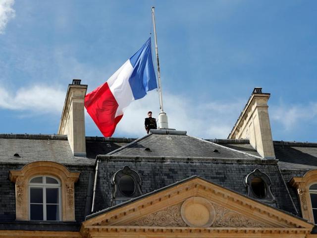 A Republican Guard pays respects after lowering the French national flag at half-mast at the Elysee Palace in Paris, France. (Reuters Photo) A Republican Guard pays respects after lowering the French national flag at half-mast at the Elysee Palace in Paris, France. (Reuters Photo)