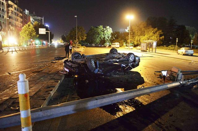 A flipped car lies in a road near military headquarters in Ankara. (REUTERS)
