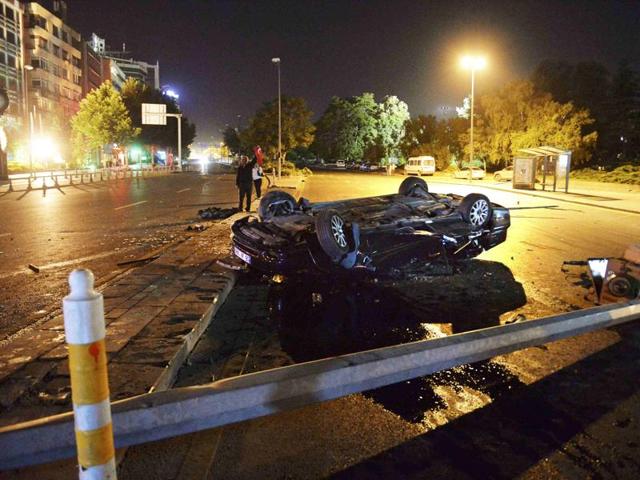 A flipped car lies in a road near military headquarters in Ankara. (REUTERS) 