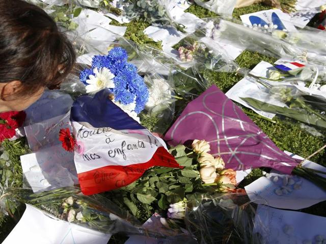 A woman is seen near flowers and a flag placed in tribute to victims two days after an attack by the driver of a heavy truck who ran into a crowd on Bastille Day. (Reuters Photo) A woman is seen near flowers and a flag placed in tribute to victims two days after an attack by the driver of a heavy truck who ran into a crowd on Bastille Day. (Reuters Photo)