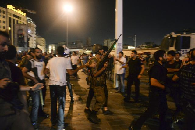 A Turkish soldier, arrested by civilians, is led to be handed to police officers, in Taksim Square in Istanbul. (AP) A Turkish soldier, arrested by civilians, is led to be handed to police officers, in Taksim Square in Istanbul. (AP)