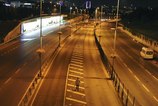 A man walks on a deserted highway in Istanbul, early Saturday. (AP) A man walks on a deserted highway in Istanbul, early Saturday. (AP)