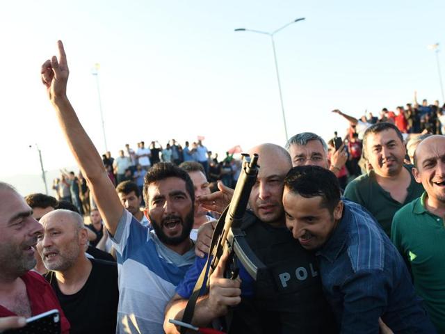 People react after they take over military position on the Bosphorus bridge in Istanbul. (AFP) People react after they take over military position on the Bosphorus bridge in Istanbul. (AFP)