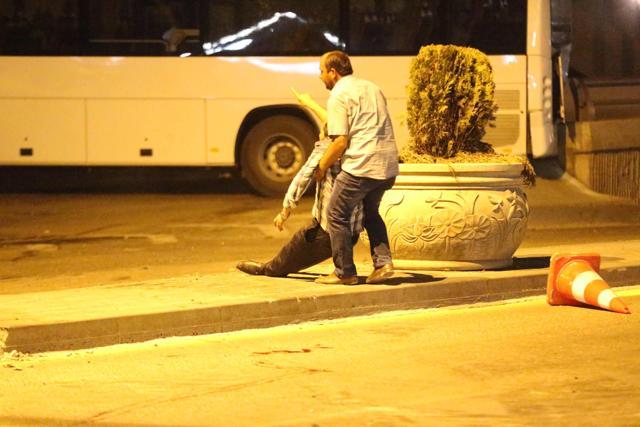 A man helps an injured person during a protest against military coup attempt in Ankara, Turkey. (AFP Photo) A man helps an injured person during a protest against military coup attempt in Ankara, Turkey. (AFP Photo)