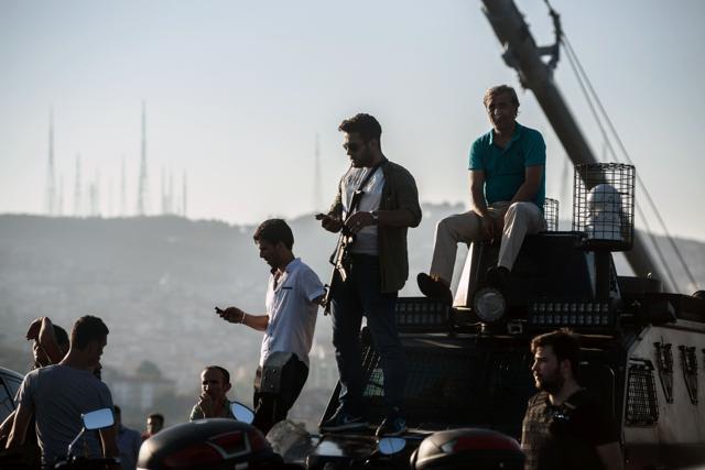 A Turkish policeman (centre) stands on a vehicle after a military position on the Bosphorus bridge was taken over in Istanbul. (AFP Photo) A Turkish policeman (centre) stands on a vehicle after a military position on the Bosphorus bridge was taken over in Istanbul. (AFP Photo)