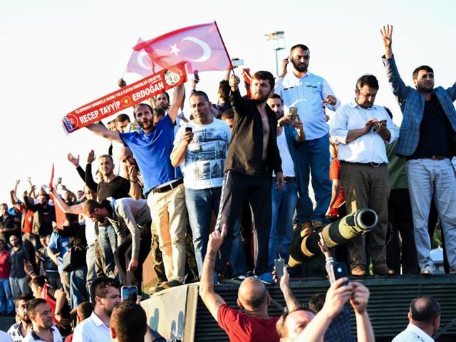 People stand and celebrate on an army tank after taking over military position on the Bosphorus bridge in Istanbul on Saturday, following an attempt by discontented soldiers to seize power from President Recep Tayyip Erdogan that claimed more than 190 lives. (AFP) People stand and celebrate on an army tank after taking over military position on the Bosphorus bridge in Istanbul on Saturday, following an attempt by discontented soldiers to seize power from President Recep Tayyip Erdogan that claimed more than 190 lives. (AFP)