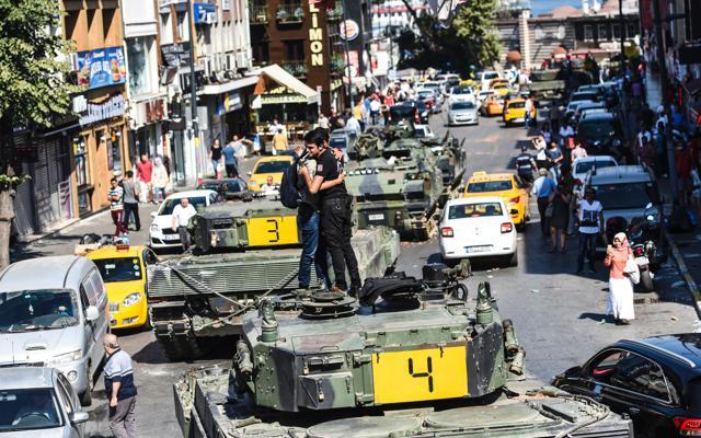Turkish police officer embrace a man on a tank after the military position was taken over at the Anatolian side at Uskudar in Istanbul on Saturday. (AFP) Turkish police officer embrace a man on a tank after the military position was taken over at the Anatolian side at Uskudar in Istanbul on Saturday. (AFP)