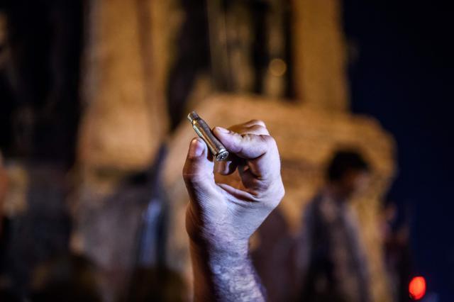 A man holds the shell of a bullet at Taksim square in Istanbul. (AFP Photo) A man holds the shell of a bullet at Taksim square in Istanbul. (AFP Photo)