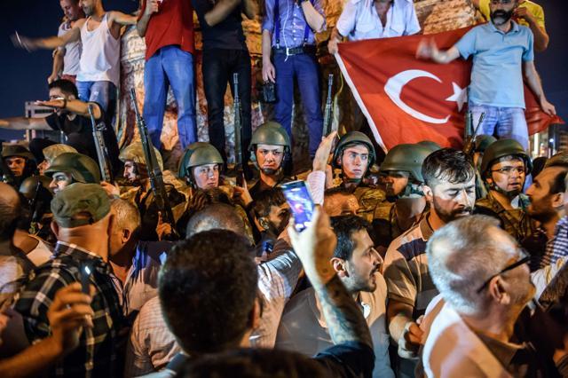 Turkish solders stay with weapons at Taksim square as people protest against the military coup in Istanbul. (AFP Photo)