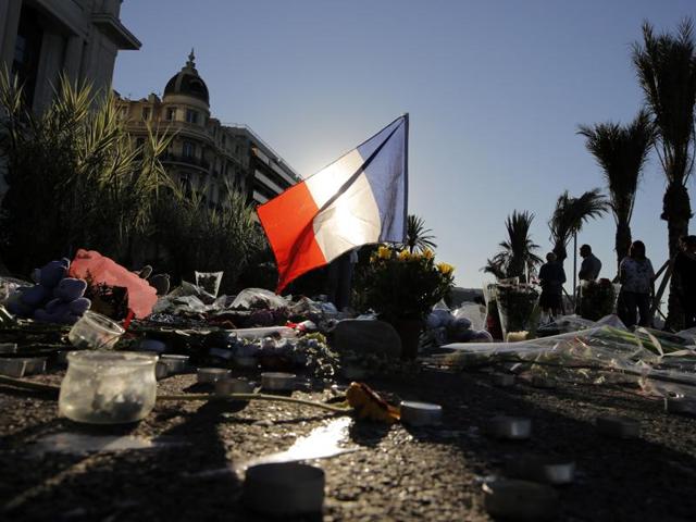 A French flag stands stall among a floral tribute for the victims killed during a deadly attack, on the famed Boulevard des Anglais in Nice, southern France. (AP) A French flag stands stall among a floral tribute for the victims killed during a deadly attack, on the famed Boulevard des Anglais in Nice, southern France. (AP)