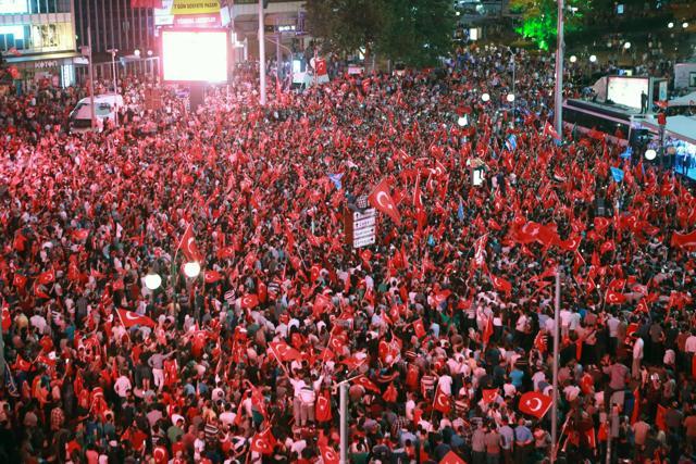 People wave flags as they gather in Kizilay Square in Ankara on July 16, 2016 during a demonstration in support to the Turkish president. (AFP Photo) People wave flags as they gather in Kizilay Square in Ankara on July 16, 2016 during a demonstration in support to the Turkish president. (AFP Photo)