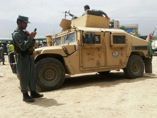 File photo of Afghan policemen at the site of a suicide attack near the international airport in Kabul on January 4.(AFP)