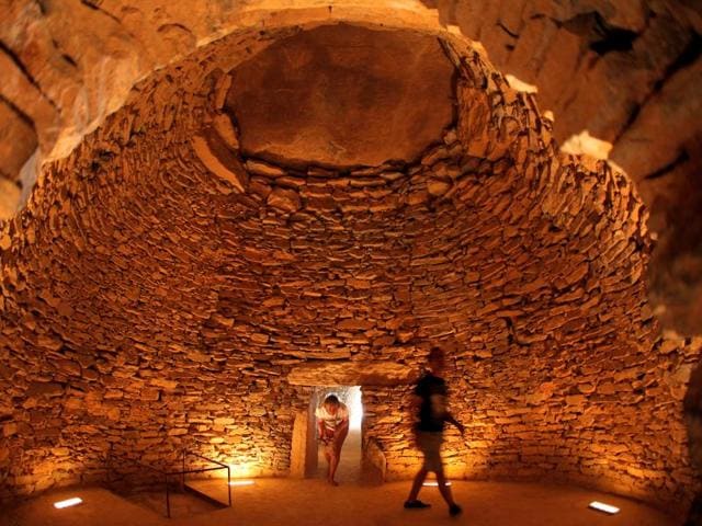 People walk inside the Tholos de El Romeral dolmen at Antequera Dolmens Site, which was recently named a UNESCO World Heritage site during the 40th Session of the World Heritage Committee held in Istanbul in Antequera, southern Spain, July 17, 2016. (REUTERS)