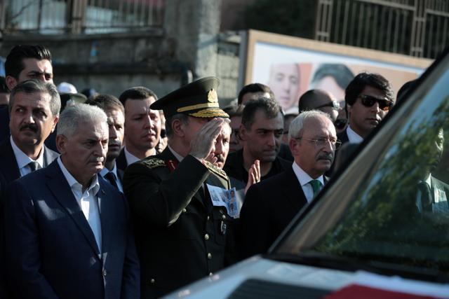 Turkey's Prime Minister Binali Yildirim (left) and Chief of Staff General Hulusi Akar stand as a funeral car carries the coffin of a police officer killed during a failed military coup, in Ankara. (AP Photo) Turkey's Prime Minister Binali Yildirim (left) and Chief of Staff General Hulusi Akar stand as a funeral car carries the coffin of a police officer killed during a failed military coup, in Ankara. (AP Photo)