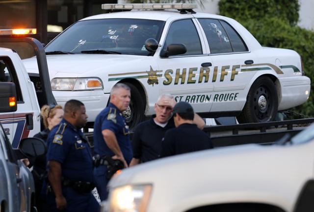 An East Baton Rouge sheriff vehicle is seen with bullet holes in its windows near the scene where police officers were shot, in Baton Rouge, Louisiana. (Reuters Photo)