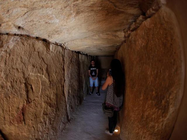 A woman takes a photo inside the Viera dolmen. (REUTERS)