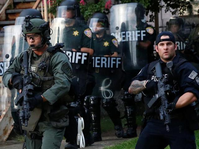 Officers march down a street during protests in Baton Rouge, Louisiana, US. (Reuters) Officers march down a street during protests in Baton Rouge, Louisiana, US. (Reuters)